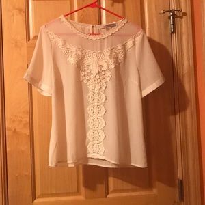 Cream colored blouse with embroidered detailing